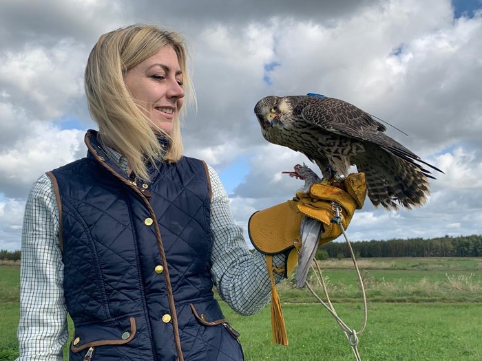 Woman holding falcon.